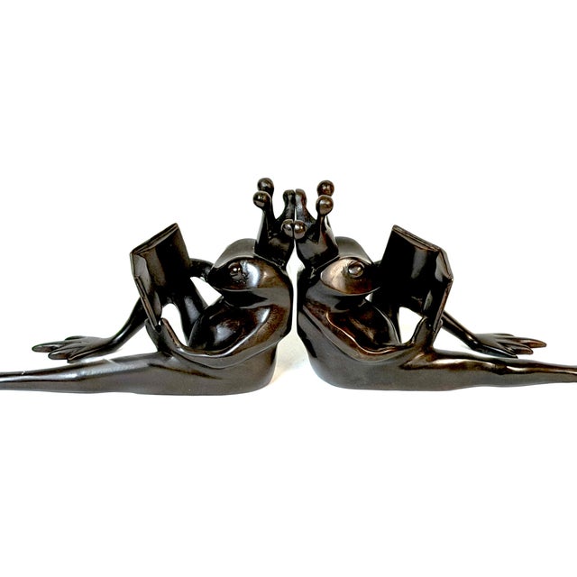Pair of Patinated Bronze Reclining Frog Prince Reading Book Bookends, Late 20th Century A whimsical and beautifully...