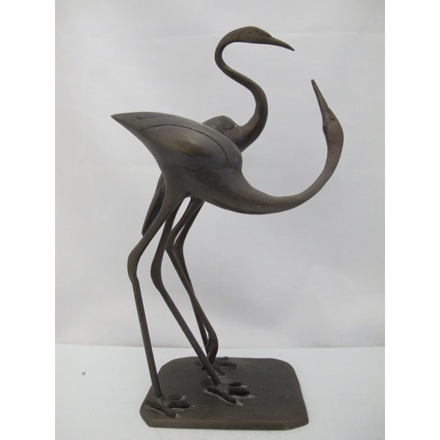 Bronze cast metal sculpture depicting a pair of stylized herons or cranes, seemingly 2 lovers. Measures 15" tall x 8" x 5...