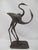 Bronze cast metal sculpture depicting a pair of stylized herons or cranes, seemingly 2 lovers. Measures 15" tall x 8" x 5...