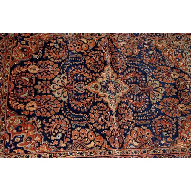 Handmade antique Persian Sarouk rug in original condition, it has some signs of age. The rug is from the beginning of 20th...