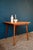 Square and small in size, this retro table from the 60s is entirely made of wood. Its spindle base is thin and elegant....