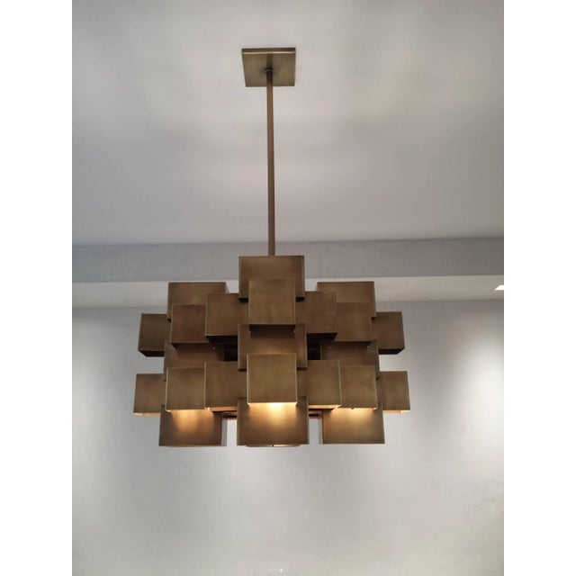 A very elegant and solid cubist chandelier in the manner of Curtis Jere. Antique brass - 26" square x 43" height Square...