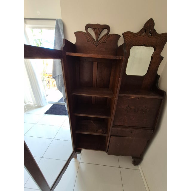 This antique American "Side-by-Side" secretary desk and curio cabinet dates from the late Victorian to early Edwardian era...