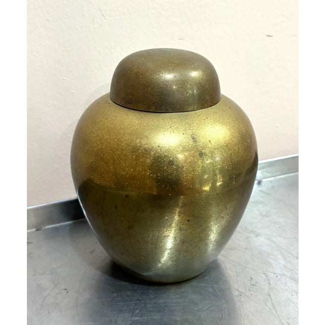 1940s-50s asian brass ginger jar. Some patina to metal throughout, including heavy patina to inside of lid as shown.