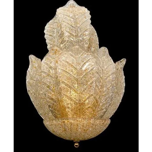 Pair of beautiful murano glass leave sconces with brass fittings. Precious hand blown Glasses with gold insertion are in...