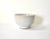 A studio or art pottery bowl, with a subtle pale blue glaze on the interior and white glaze outside. 4"x2.5".