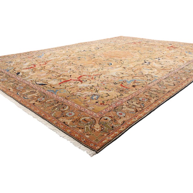 79014 Vintage Persian Tabriz Rug, 10'08 x 15'03. This hand-knotted wool vintage Persian Tabriz rug is a vibrant array of...