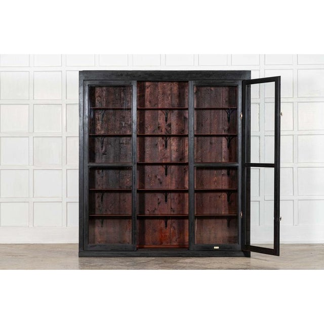 circa 1880 Large English 19thC Ebonised Mahogany Pharmacy Display Cabinet Two sliding doors and one outward opening door...