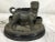 19th century French terra cotta match safe with dog standing in front of three baskets. Age wear.
