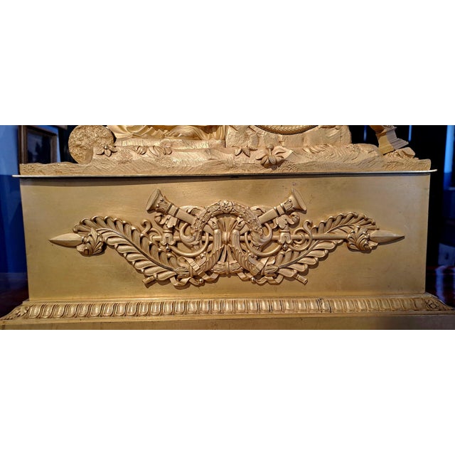 Mercury-gilt bronze clock depicting the allegory of music. The female figure, Erato, muse of lyric and love poetry, is...