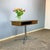A cool and practical little table with the typical four-legged chrome base of the 70s. Its swivel function and open...