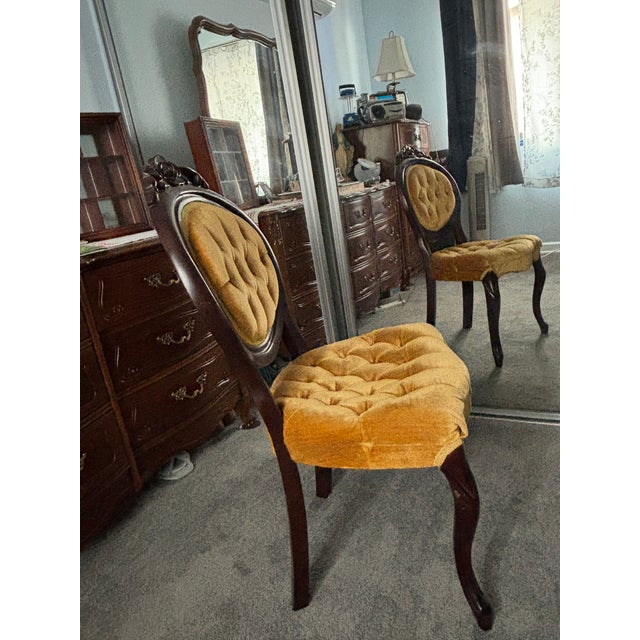 Vintage Victorian Style Accent Chair. Dark Wood Frame (possibly Mahogany). Gold colored Velvet Tufted upholstery with...