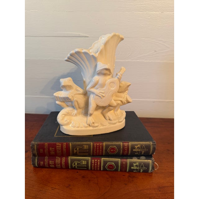 A frog trio makes delightful music on this pair of all-white, pottery vases. These cuties were made between 1921 and 1941...