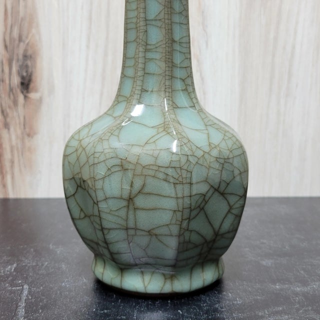 Finely potted Chinese Guan ware porcelain vase in the style of the Southern Song Dynasty. A bottle form vase with lobed...