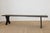 Dimensions: 14.5"D x 84"L x 19"H A beautiful antique oak bench with a rich, darkened patina and sculptural cut-out legs—an...