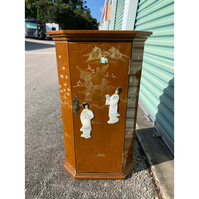 Beautiful Carmel color Asian style cabinet with shelves inside. Tall enough to be a pedestal or small console table....
