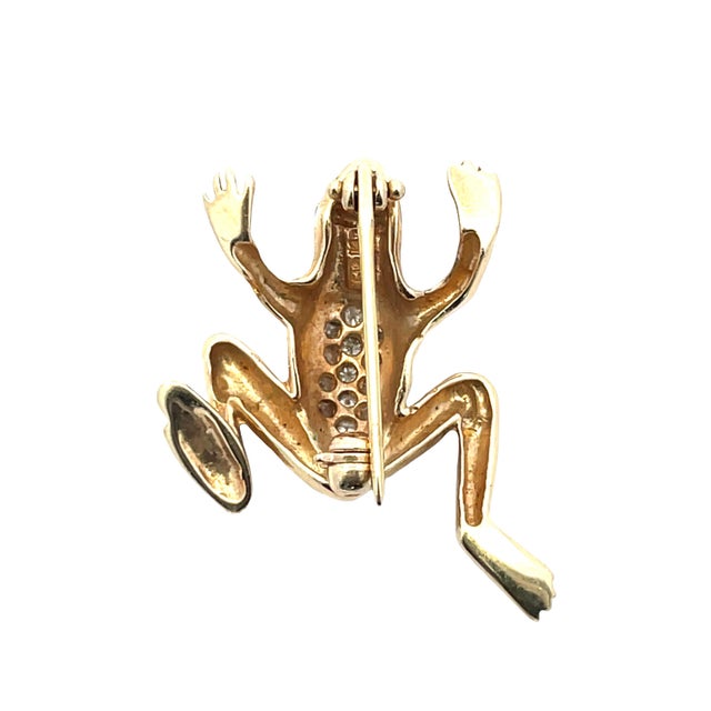 Charming 14K yellow gold frog brooch featuring a playful sculptural design with a diamond-set back totaling approx. 0.11...