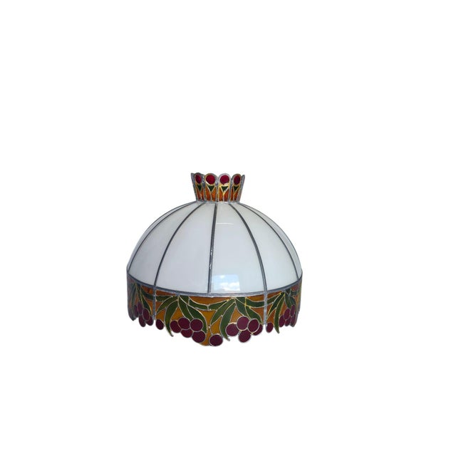 A charming vintage table lamp in the classic Tiffany style from the 1960s or 1970s. The dome-shaped lampshade is made of...