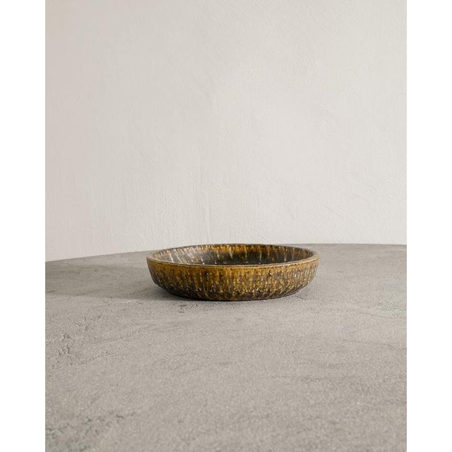 Rare and large Swedish mid century decorative ceramic dish in brown golden galze from the series "Rubus" by Gunnar Nylund...