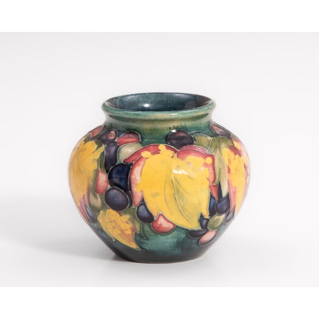 An early William Moorcroft "Potter to H.M. the Queen" Leaf and Berry Art Pottery cabinet vase. Excellent condition with...