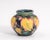 An early William Moorcroft "Potter to H.M. the Queen" Leaf and Berry Art Pottery cabinet vase. Excellent condition with...