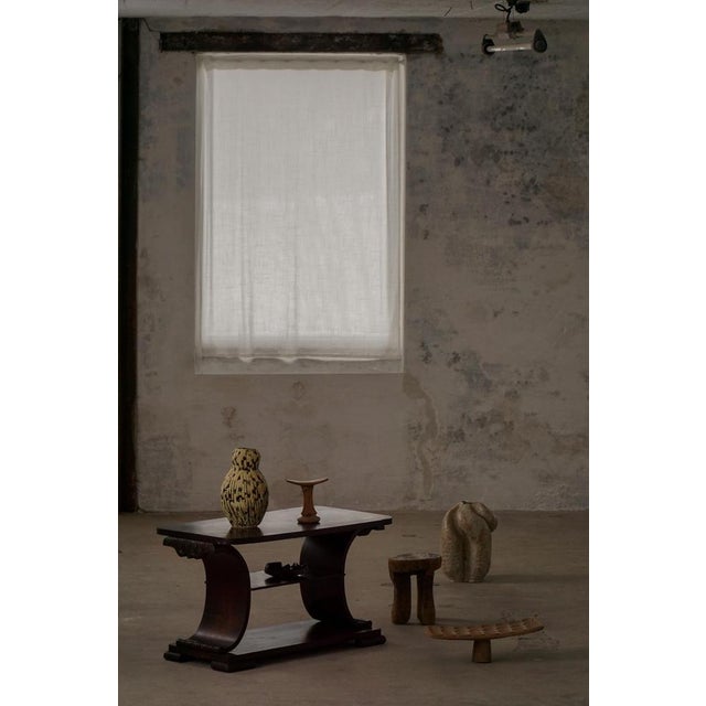 An elegant example of Dansih Art Deco furniture, this dark wood coffee table reflects the clean lines and understated...