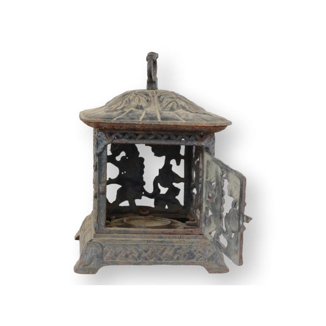 Midcentury Japanese cast iron pagoda-form lantern featuring beautifully cast grapevine motifs in openwork panels, allowing...