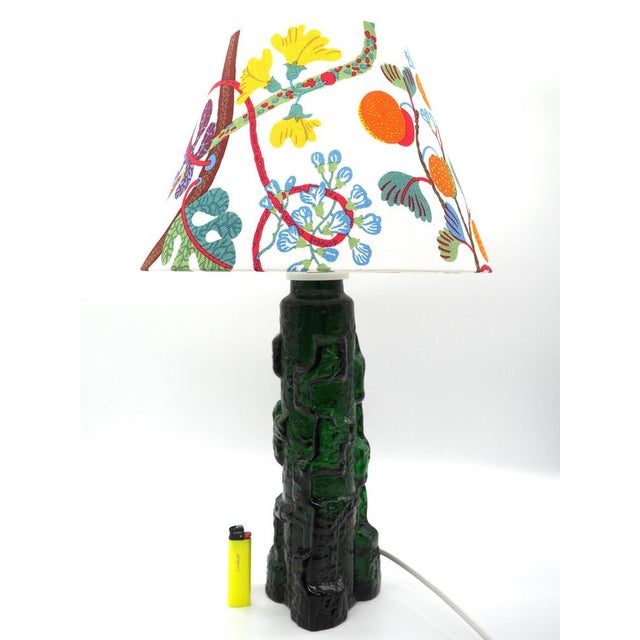 A wonderful lamp that shimmers in the light with its deep green color. a table lamp evoking a rocky outcropping by...