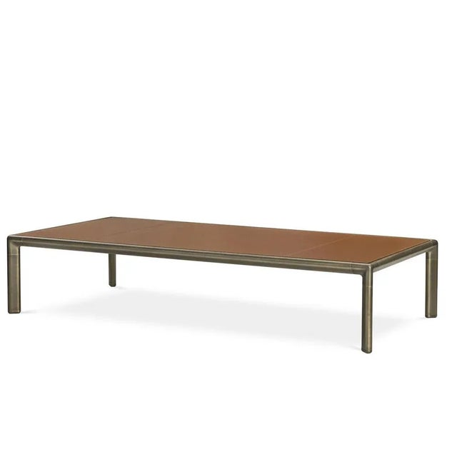 Elegant and functional, the Frame Coffee Table in aluminum, wood and burnished brass with leather on the top is ideal in...