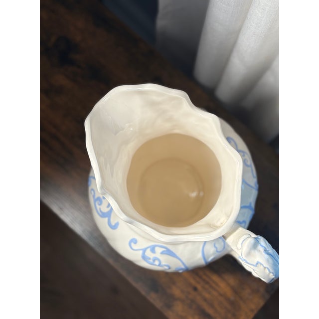 A charming piece, this large Victorian-style wash pitcher features an elegant cream/ivory glaze adorned with hand-painted...