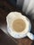 A charming piece, this large Victorian-style wash pitcher features an elegant cream/ivory glaze adorned with hand-painted...