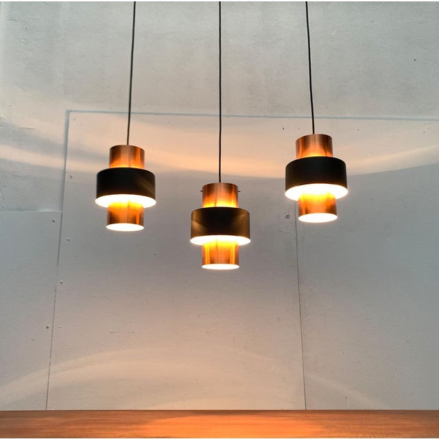 Mid Century Dreier Cascade in copper and black. Simple pendulum with a cylindrical basic shape. The contrast of copper and...