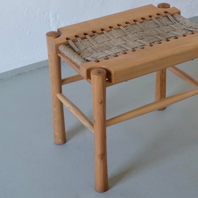 Vintage carved wood stool with a woven seat. The right one is available.