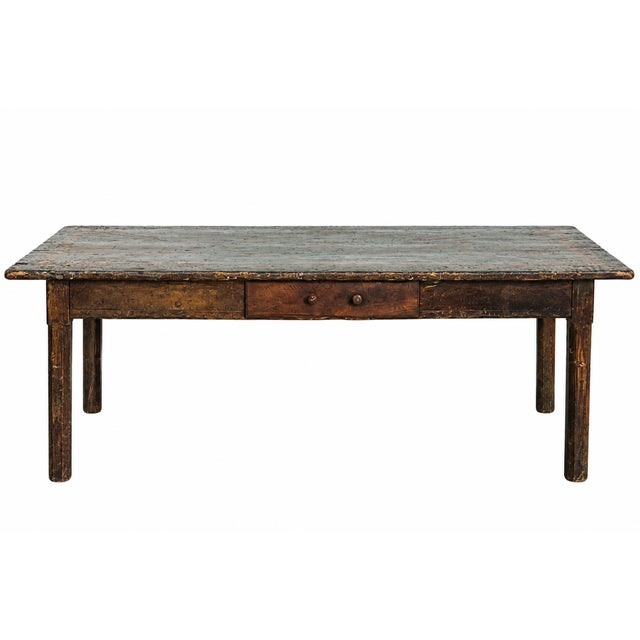 A wonderfully timeworn 18th-century Italian farmhouse table featuring a distinctive geometric inlaid top and centuries of...