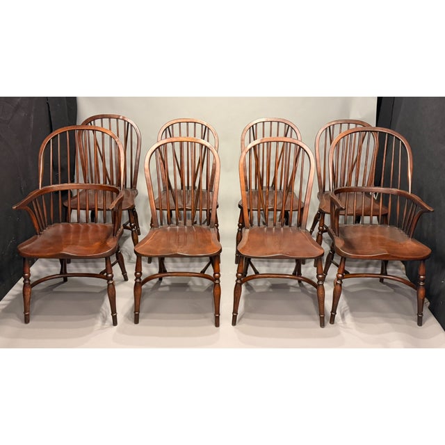 A custom set of 8 of English Windsor dining chairs, handmade in England circa 1995. Crafted from oak and ash, this set...