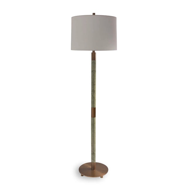 Natural green stone marble turnings are accented with aged brass finished metal hardware for this Jade Garden floor lamp....