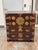 Design Plus Gallery presents a Japanese Gilt-Mounted Tansu Chest by Lord Co. This vintage chest has a reddish-brown wood...