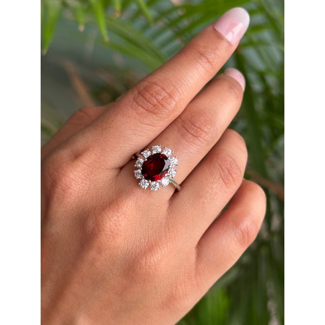 This stunning ring is meticulously handcrafted in 925 Solid Silver, showcasing a captivating oval Garnet gemstone of 4.34...