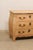 A French wooden bow-front chest of three drawers. This vintage commode from France has a slightly overhanging top lip,...