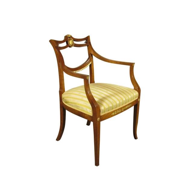 A 19th-C. Swedish Neoclassical walnut arm chair with hand carved gilded details.
