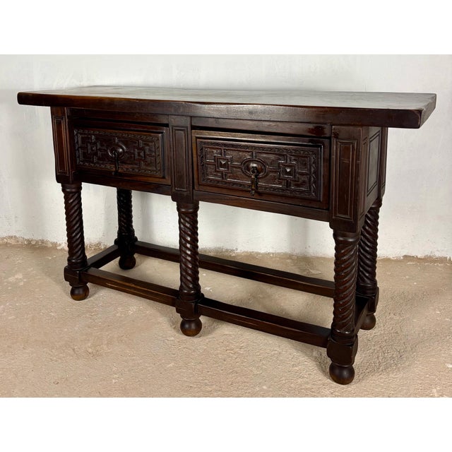 Striking Spanish console table from the late 19th century, crafted in solid walnut and inspired by traditional Baroque...