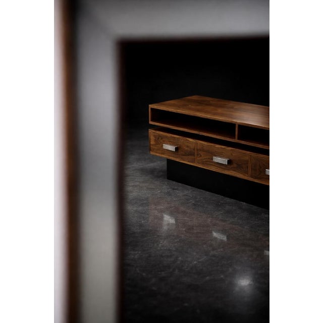 This modernist console table with a mirror, the ambassador model, was made by the swedish manufacturer fröseke...