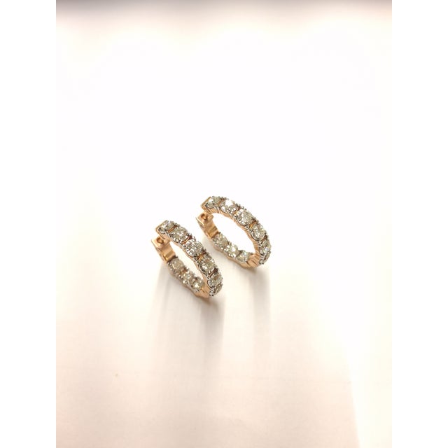 A polished update to the classic hoop, these 10K Rose Gold earrings are set with round natural diamonds for continuous...