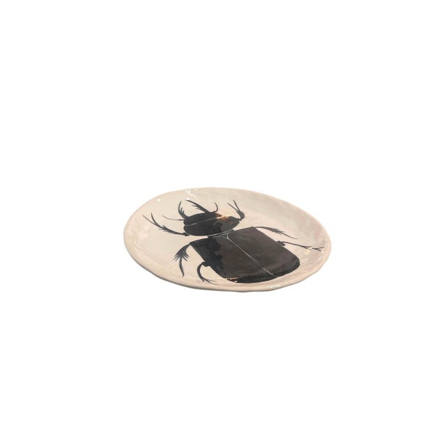 This striking vintage studio pottery decorative charger plate pairs an organic, artisanal form with a bold, graphic...