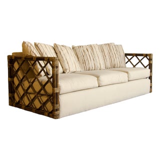 Vintage Rattan Trellis Lattice Sofa in the Style of McGuire With Casters, Wrapped Joints, and Ivory Upholstery, 1970s For Sale