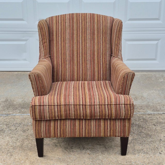 This is a handsome large-scale transitional style wingback chair made in the United States by Stratford, a division of...