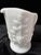 This Westmoreland milk glass pitcher features the classic Paneled Grape pattern, showcasing detailed embossed grape...