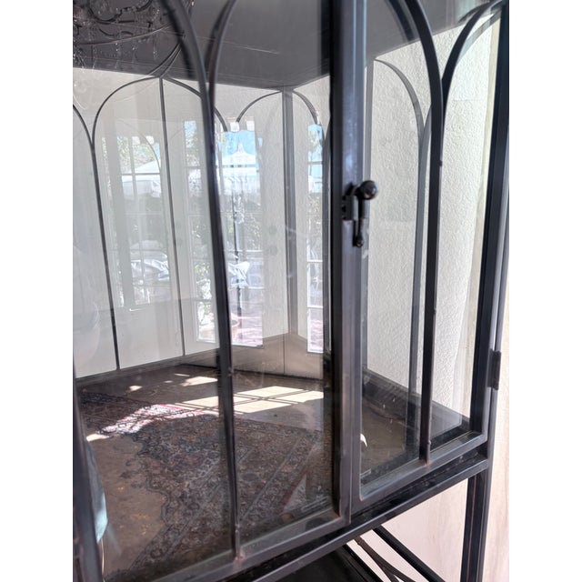 A spectacular oversized Gothic-style iron and glass vitrine with soaring cathedral-window tracery and a dramatic...