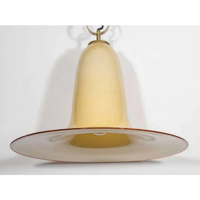 Mid-Century Modern large pendant chandelier with stunning elongated bell formation. Handblown Murano glass in hues of...