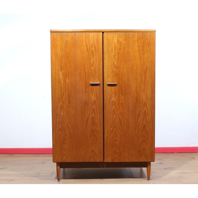 Discover a stunning armoire that perfectly captures the timeless elegance of Mid Century Modern design. Crafted from rich...